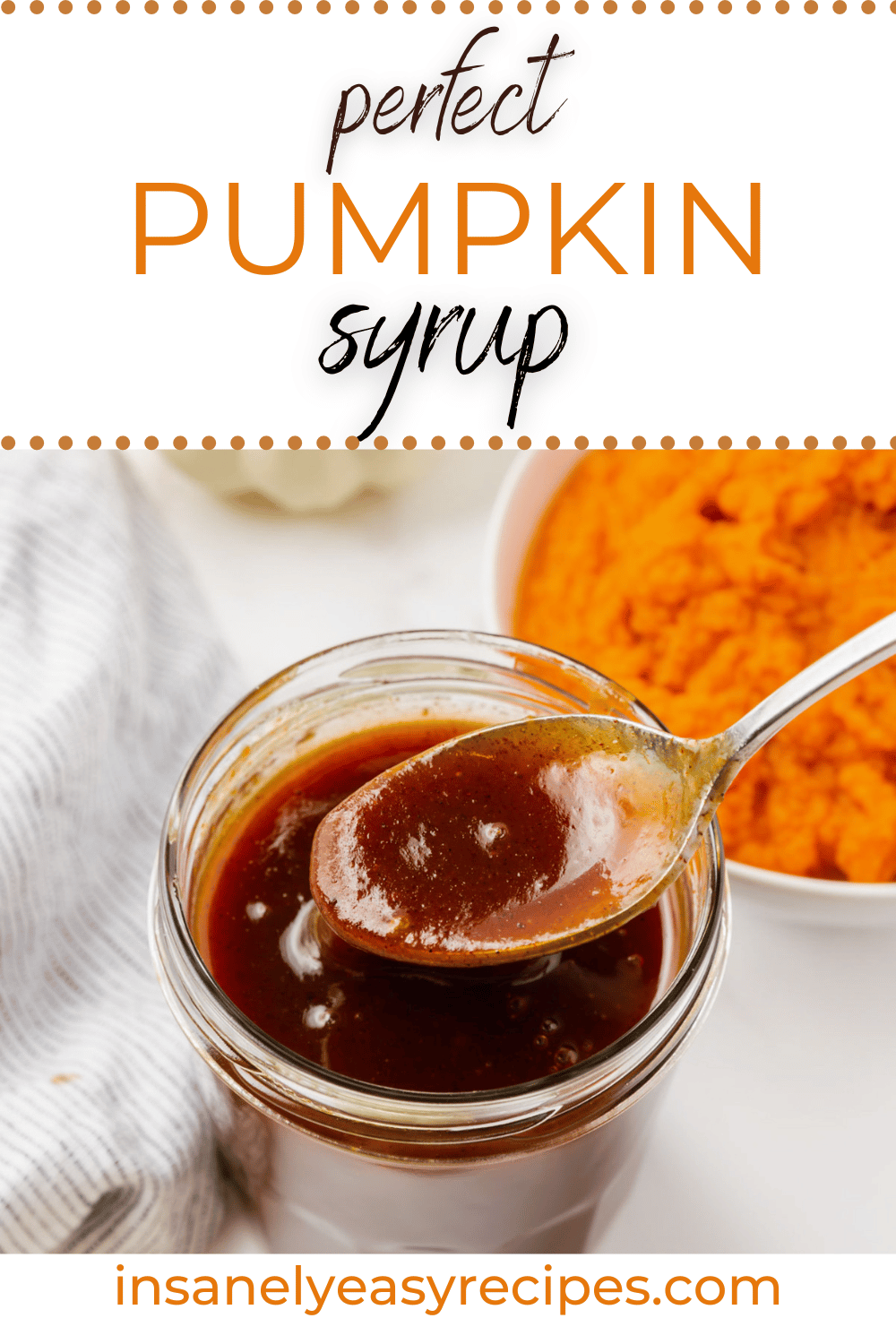 glass jar with brown liquid, metal spoon dipping into the liquid and some pouring off spoon. Top right corner has puree pumpkin in a white bowl. Gray napkin to left side. with text overlay perfect pumpkin syrup