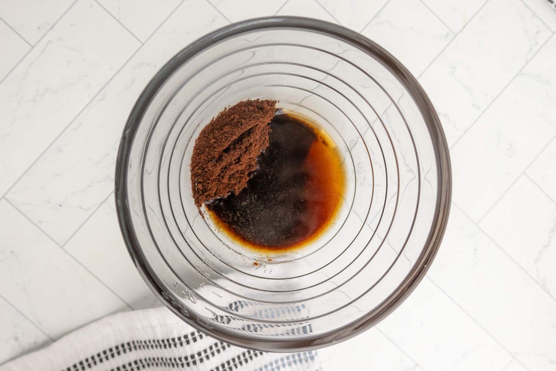Instant coffee and water in a glass bowl.