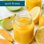 Small glass jars filled with yellow ginger turmeric shots are surrounded by lemon wedges, ginger, and turmeric root on a white surface. Text overlay reads “Ginger Turmeric Shots, quick & easy.”.